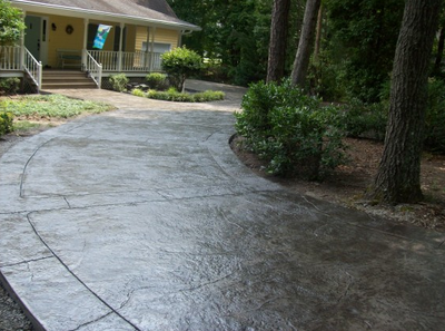 Long dark stained, and textured concrete driveway in Roanoke.