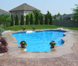 Stained textured edging around pool with stamped and stained concrete deck.